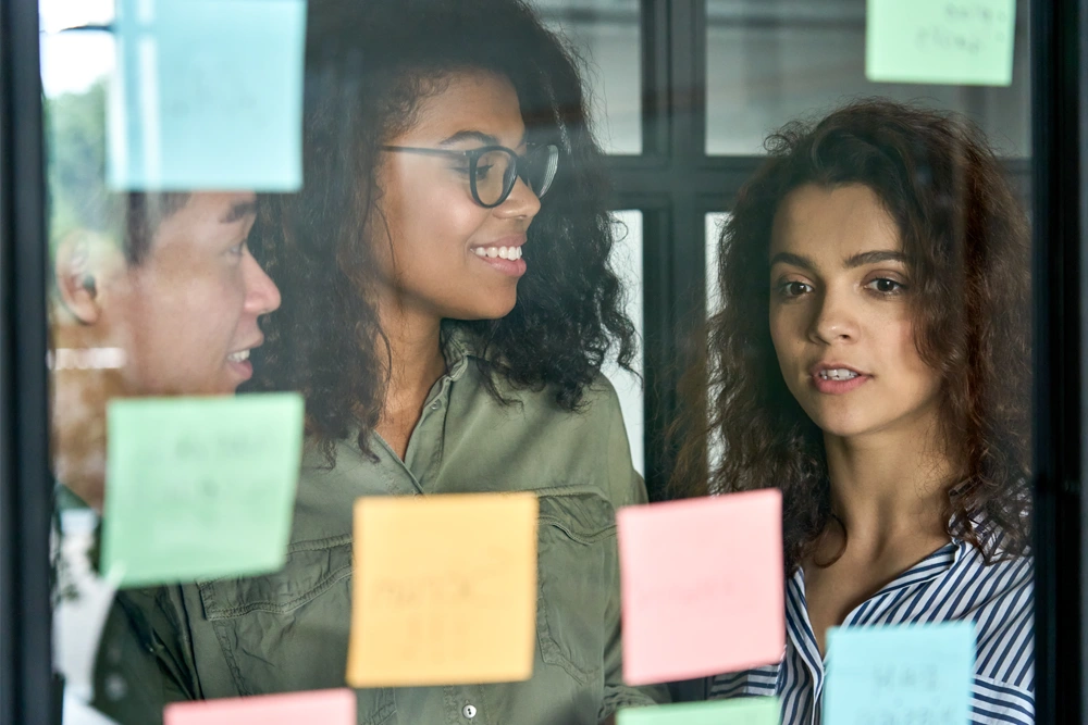 multiethnic-coworkers-discussing-project-in-office-
